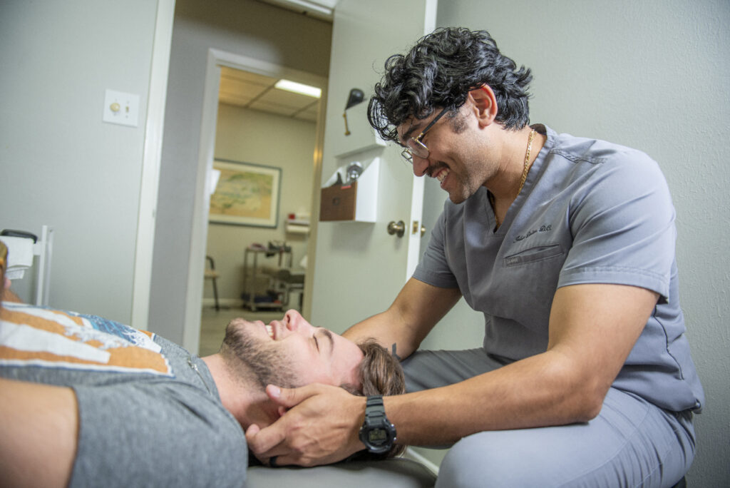 dr. julian dalton offering chiropractic care to patient