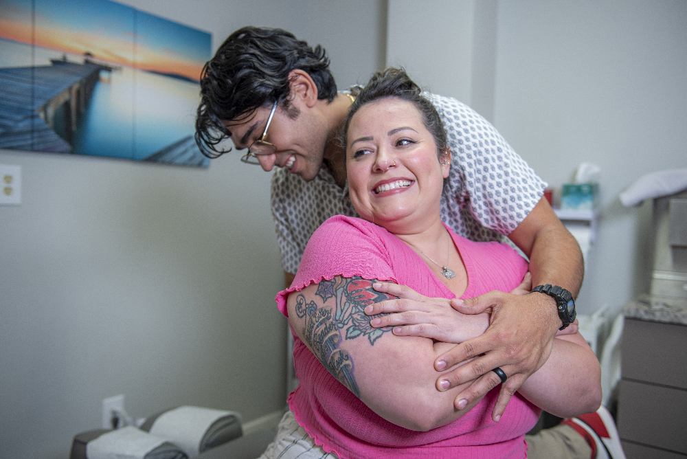 dr. dalton performing manual therapy on smiling patient