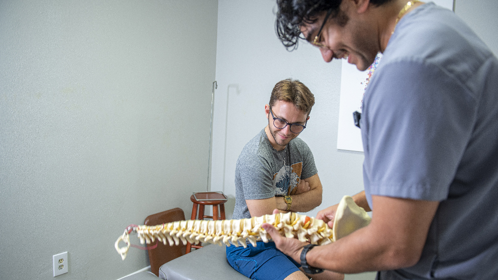 dr. julian dalton explaining scoliosis to a patient