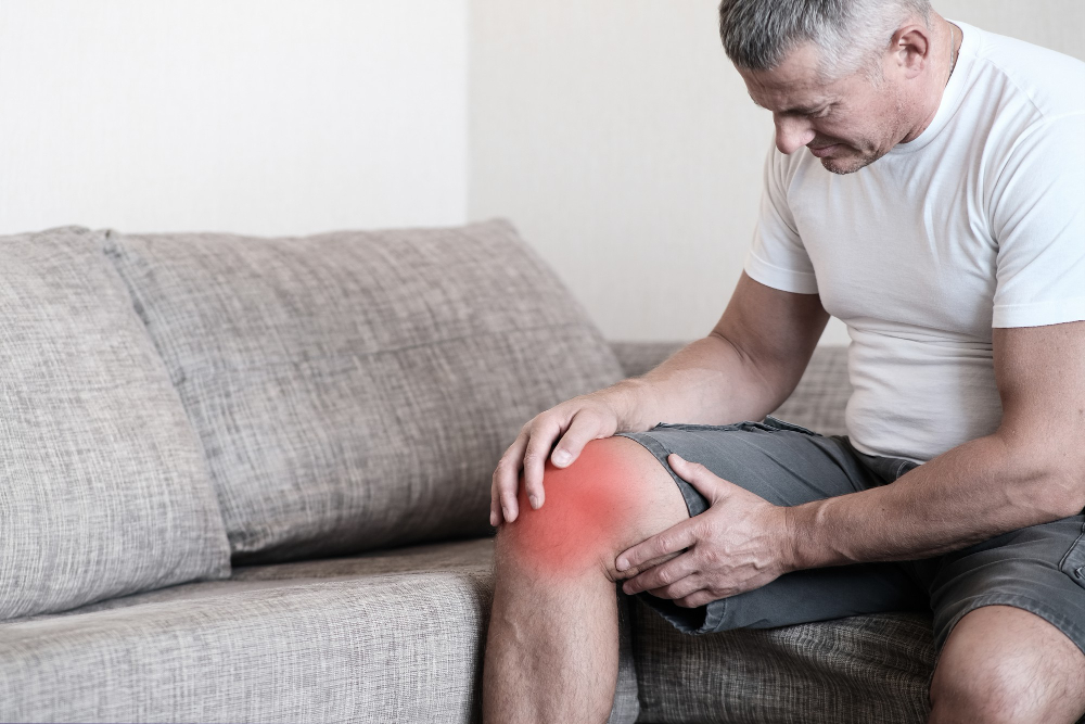 mature man grabbing his knee due to limited range of motion