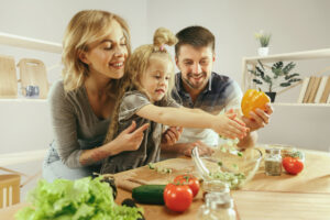 healthy family preparing foods that help with boosting immunity paired with chiropractic care