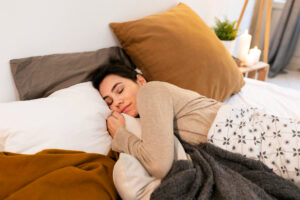 chiropractic care and better sleep with woman sleeping in bed after session