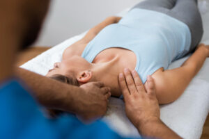 woman on table getting a neck adjustment for preventative chiropractic care